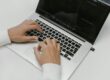 Free Hands on a Laptop Keyboard Stock Photo