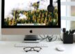 Free Stylish home office workspace featuring a computer setup with accessories. Stock Photo