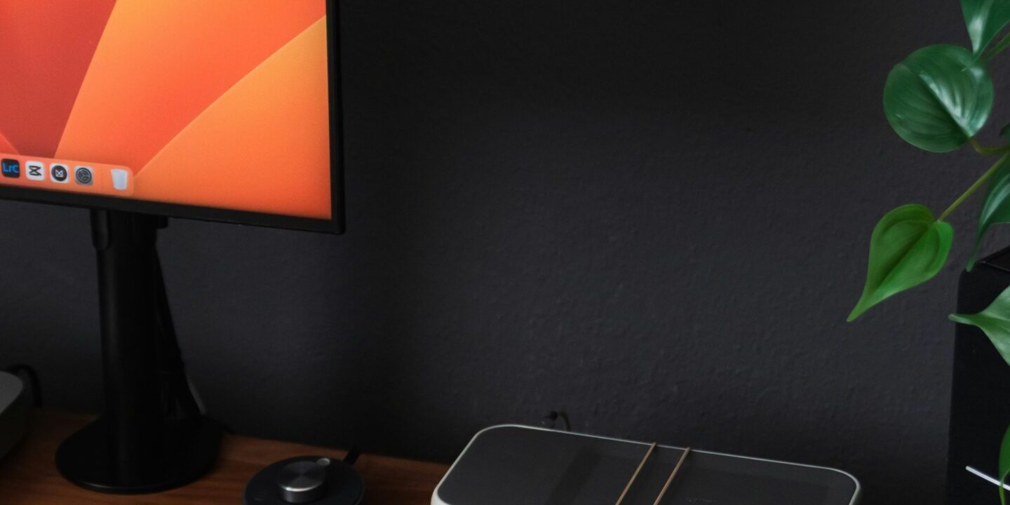 Project-Chaos-to-Clarity-How-Microsoft-Planner-Transforms-Small-Businesses-scaled.jpg a desk with a laptop, keyboard, mouse and a monitor