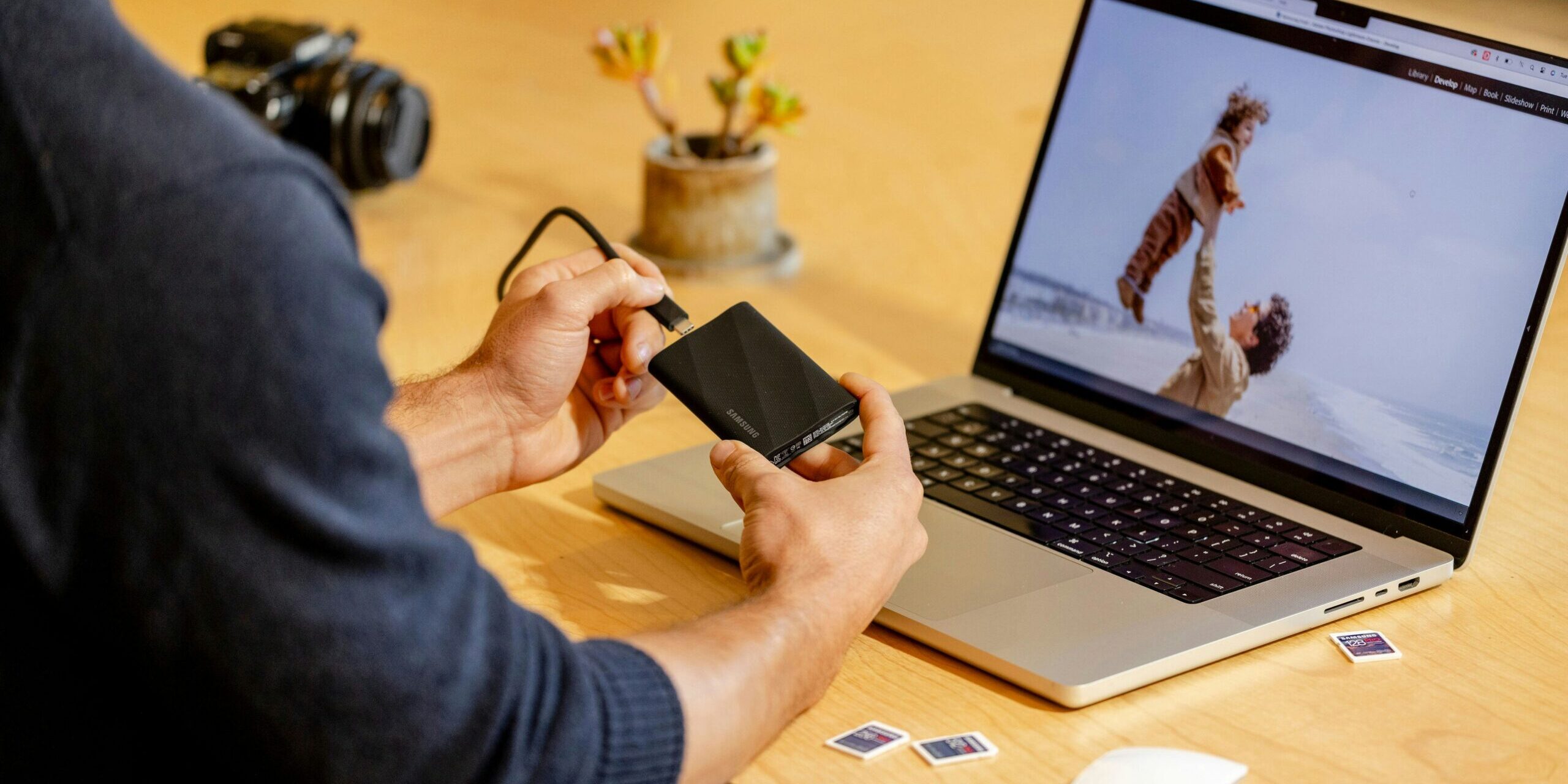 The-_Backup-Exit_-Strategy_-Can-You-Move-Your-Data-Without-the-Vendors-Help_-scaled.jpg A man sitting at a table with a laptop and cell phone