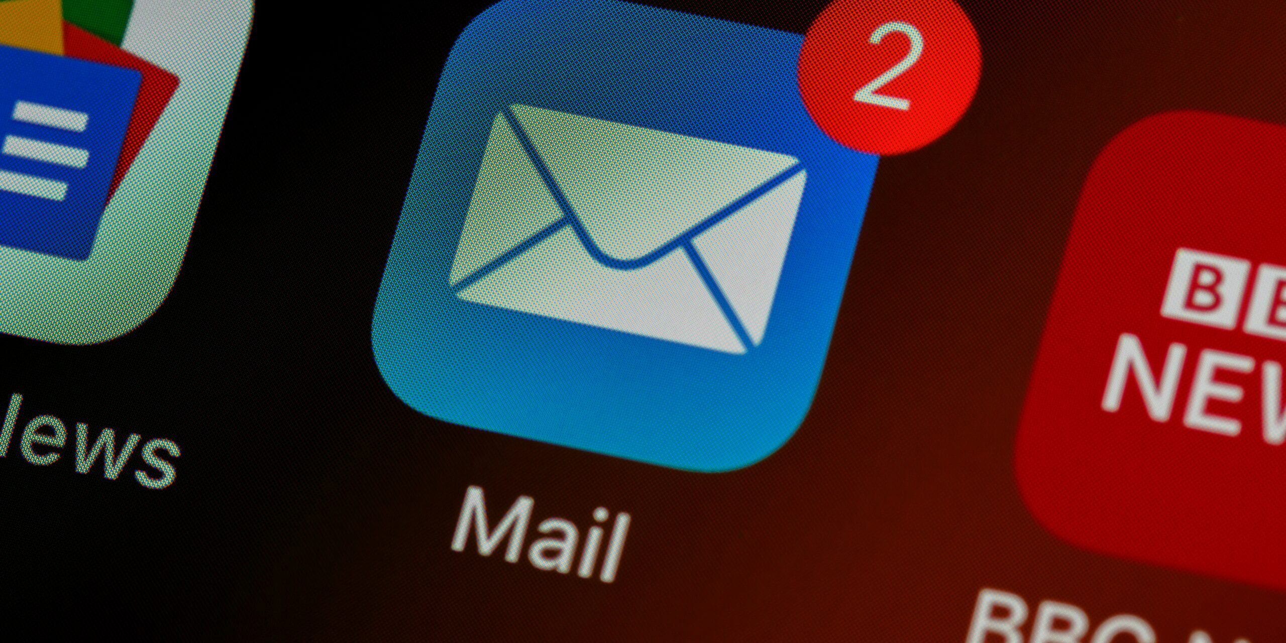 brett-jordan-LPZy4da9aRo-unsplash-scaled.jpg closeup of mail app icon on phone