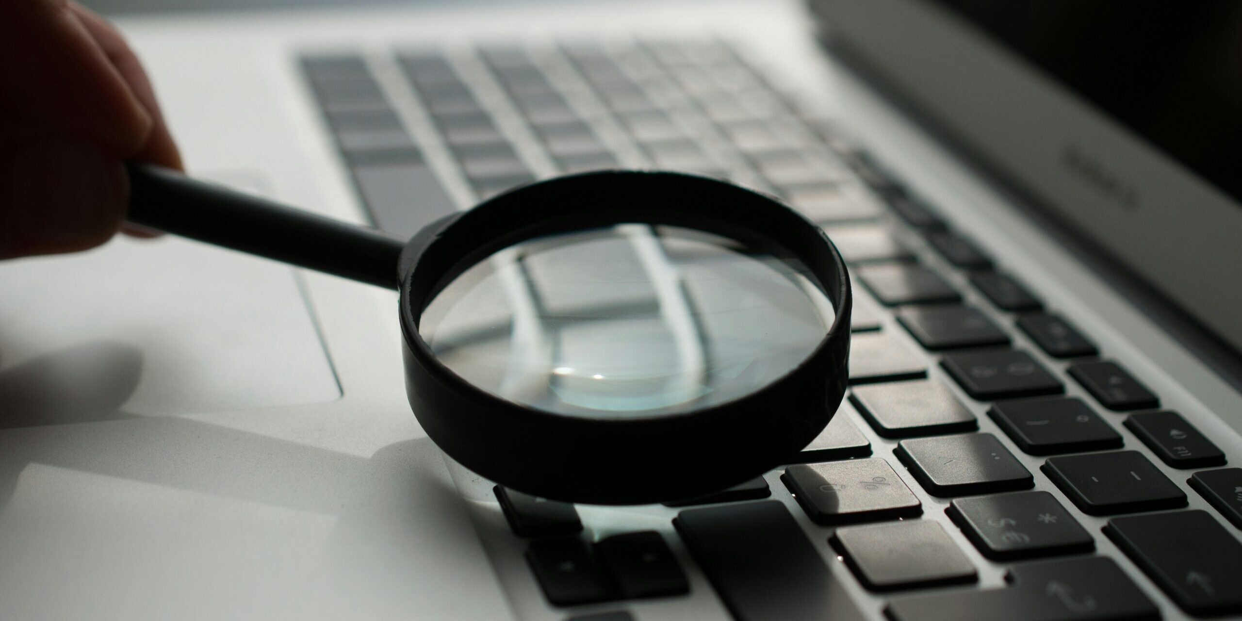 agence-olloweb-d9ILr-dbEdg-unsplash.jpg magnifying glass near gray laptop computer