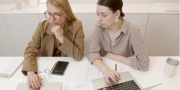 two women with laptops
